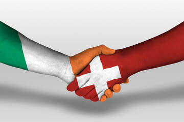 Handshake between switzerland and ireland flags painted on hands, illustration with clipping path.