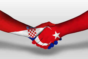 Handshake between turkey and croatia flags painted on hands, illustration with clipping path.