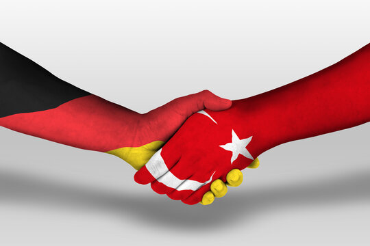 Handshake between turkey and germany flags painted on hands, illustration with clipping path.