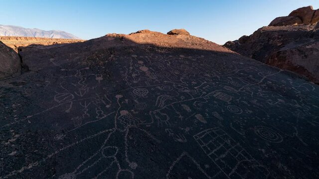 Time lapse of sun light revealing Native American rock art panel in California