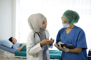 Serious Asian female doctors team discussing patient's case in the room at the hospital