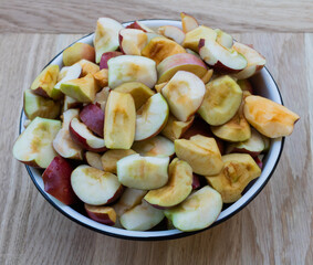Apples in a bowl on a wooden background, In the process of cooking apple juice