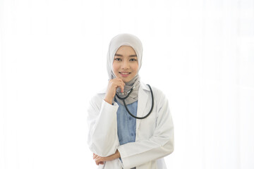 Portrait of Asian muslim female doctor smiling and looking to camera on white background