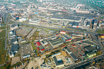 aerial panoramic view of city industrial district with many manufacturing buildings and warehouses