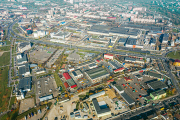 Fototapeta premium aerial panoramic view of city industrial district with many manufacturing buildings and warehouses