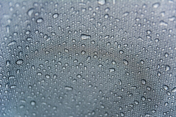 Close-up shot of water droplets on the tent. Macro photography. Camping in spring, summer and autumn. Background with space for text.