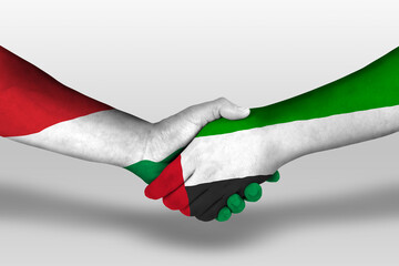 Handshake between united arab emirates and hungary flags painted on hands, illustration with...