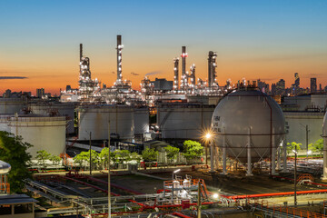 Oil refinery plant at sunset, The night view of petroleum and petrochemical factory with distillation column, drum and pipeline. Gas, diesel and chemical business industry is important for economy.
