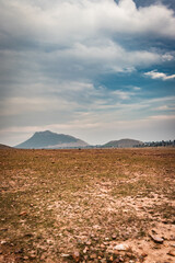 countryside empty rural area cover with mist and surrounded by mountains at morning