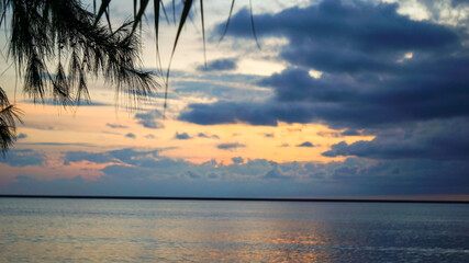 A cloudy orange evening sky at the beach