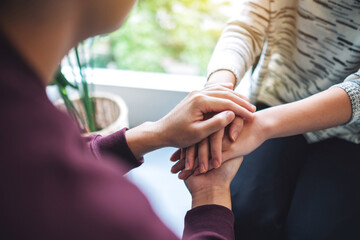 A man and a woman holding each other hands for comfort and love