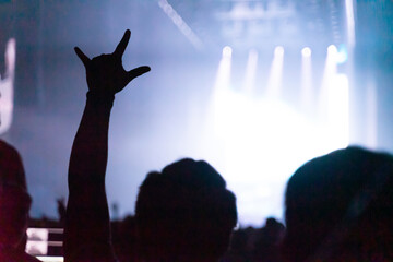 concert playing in a crowded hall with the lights in the dark and the noise in the blur