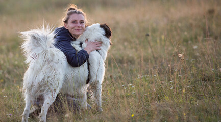 happy woman with white dog in autumn landscape