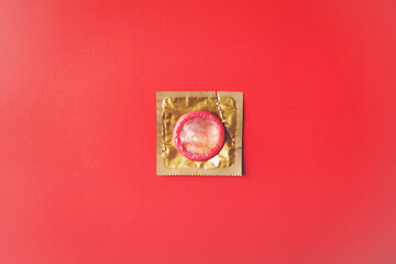 World sexual health or Aids day, Top view flat lay condom in wrapper pack is tear open, studio shot...