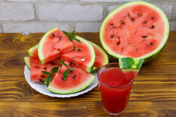 Glass of fresh watermelon juice on a wooden table