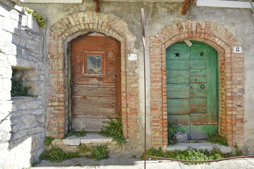 Fototapeta premium Old wooden doors of an abandoned house in Cercemaggiore, a rural village in the Molise region, Italy.