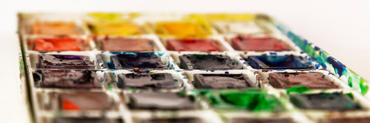 Art Palette with Colorful Paints Close Up View. Open Aquarelle Watercolor Palette multicolor