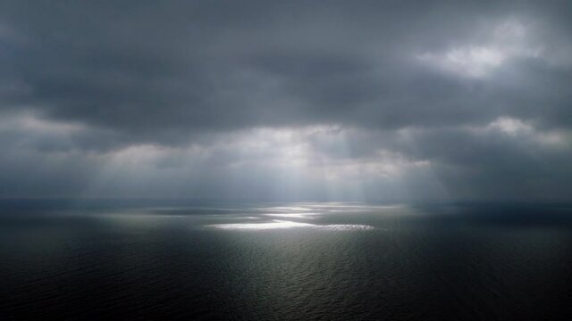 Scenic seascape. Beautiful rays of sun breaking through the clouds over The Black sea. 4K