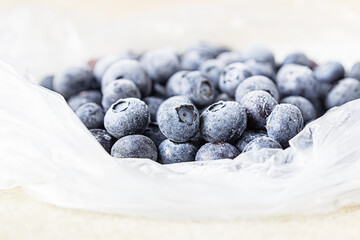 Frozen blueberries in transparent plastic bag. Close up. Concept of healthy eating.
