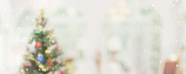 Abstract  blurred bokeh Christmas tree with snowfall  banner background. Christmas and Happy new year concept.