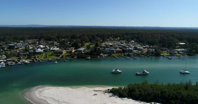 360 degrees aerial hover over Huskisson town waterfront on Jervis bay.
