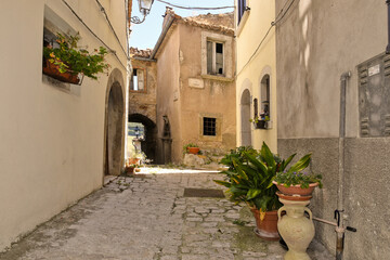 Fototapeta na wymiar A narrow street among the old houses of Riccia, a rural village in the Molise region.
