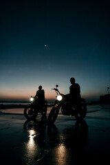 Two custom motorbikes at the beach during sunset, in Bali Indonesia