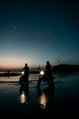 Two custom motorbikes at the beach during sunset, in Bali Indonesia