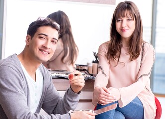 Man doing make-up for cute woman in beauty salon