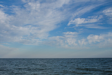 Naklejka na ściany i meble sea water with blue bowls and clouds