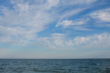 sea water with blue bowls and clouds