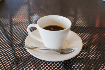 a cup of coffee on the table in a coffee shop