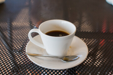 a cup of coffee on the table in a coffee shop