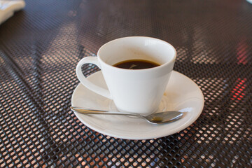 a cup of coffee on the table in a coffee shop