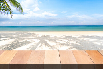 Wood table bar and beach sea sand and palm in summer sun.