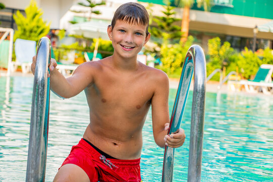 Young boy summer happy and contented in the pool in the summer