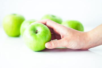 Hand holding green apple