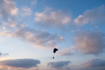 Motorized paraglider in amazing sunset sky above Ashkelon`s Marina