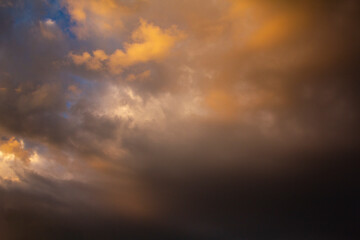 The sky before the storm with clouds of heavy dark dramatic tones. Colorful sky during natural disasters.