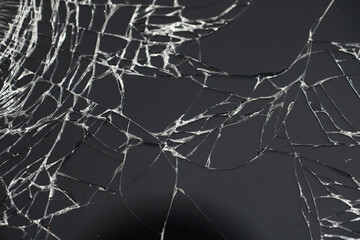 Crack on the glass. Broken screen. Broken phone. Cracked glass background. White cracks in the glass.