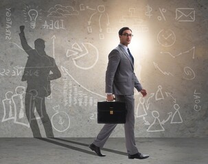 Businessman and his shadow in business concept