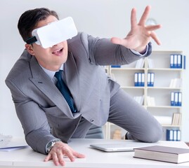Businessman with virtual reality glasses in modern technology co