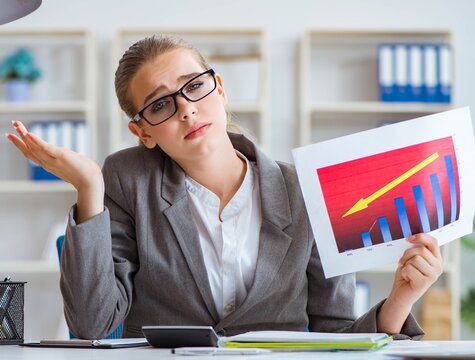 Young businesswoman in crisis concept