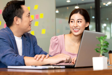 Business man and woman talk about job on labtop in office in morning