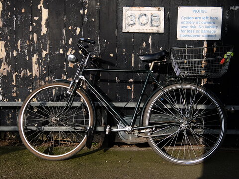 Vintage bicycle parked in front of a wall