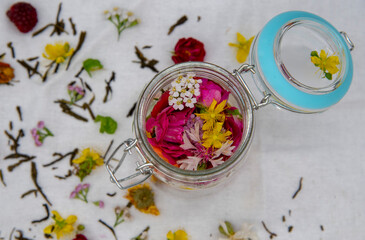 Obraz na płótnie Canvas Fresh aromatic medicinal herbs in a glass container.
