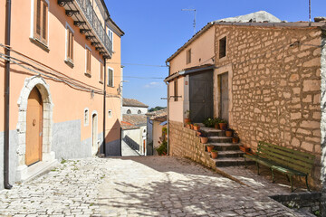 Fototapeta na wymiar A narrow street among the old houses of Sepino, a medieval village in the Molise region.