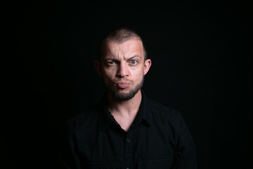 Emotional man portrait on black background