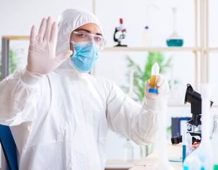 Young chemist student working in lab on chemicals