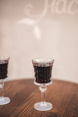 Glass of red wine, cheeses and grapes on the lights background. Drink, organic.
